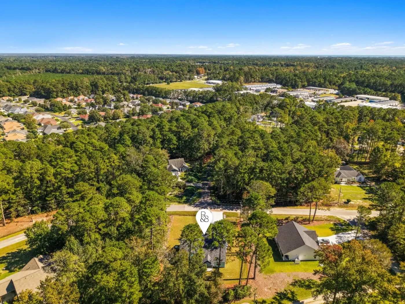 Aerial with a branded location pin on the property